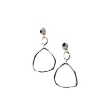 Elegant long triangle dangle earrings in hammered silver metal, featuring a unique geometric shape and stainless steel studs.