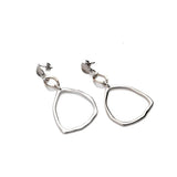 Hammered triangle earrings in silver with a long, geometric dangle design, featuring oval stainless steel earring pins.