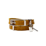 Yellow leather wrap bracelet featuring a bold metal buckle and a clasp with an adjustable chain for a customized fit.