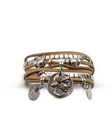 Suede boho bracelet featuring four strands, silver-plated cube beads, and ancient coin charms, in beige tones.