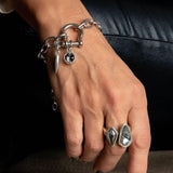 Edgy silver bracelet featuring a shackle pendant, Swarovski crystal charms, and a chunky stainless-steel chain.