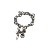 Chunky rock-style silver bracelet featuring a grey Swarovski crystal charm, shackle pendant, and textured steel chain.