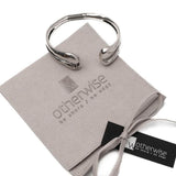 Unique hammered bangle bracelet with an open cuff design, silver finish, displayed on a suede gift pouch.