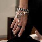 Edgy stainless steel bracelet with black leather in chain and oversized buckle, chunky wrap rocker cuff