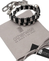 Black and silver chain bracelet on a branded cloth with 'otherwise' logo.