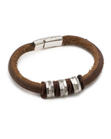 Brown leather bracelet with silver beads and clasp on a white background