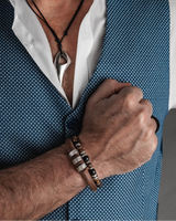 Person wearing a blue patterned vest over a white shirt, with a focus on the chest area.
