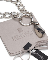 Chunky sterling silver plated chain necklace featuring a champagne crystal pendant, displayed on a suede pouch.