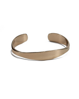 Rose gold cuff bangle made of flexible metal, featuring a sleek, minimalist design, adjustable fit for comfort.