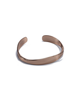 Rose gold cuff bangle with a sleek, flexible design, adjustable fit, perfect for stacking or wearing alone.