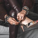 Edgy wrap-around black leather bracelet with silver-plated designs