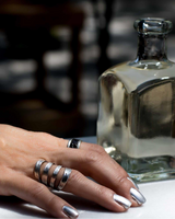 Funky hammered silver-plated metal ring displayed on a finger, showcasing a unique chunky design and adjustable fit.