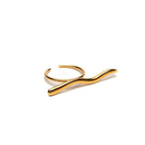 Gold adjustable statement ring with a funky geometric design, featuring a smooth curved bar shape in stainless steel.