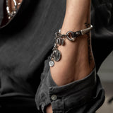 Silver charm bracelet, leather and metal bracelet with coins