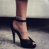 Dainty 999 silver antique plated anklet with round charms, worn above a black high-heeled sandal.