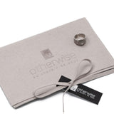 Silver plated adjustable ring featuring a dark ethnic cone design with dotted accents, displayed on a suede pouch.