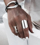 Adjustable silver-plated chunky ring set worn on a model's hand, showcasing bold, wide designs and a mix of styles.