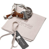 Bold snake chain bracelet featuring a woven brown leather band and metal accents, with an engraved "Otherwise" tag.