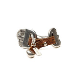Bold snake chain bracelet featuring a neutral woven leather band in warm brown, with metal accents and an engraved tag.