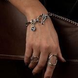 Chic stainless steel bracelet with "Silver Night" Swarovski crystal charm and T-bar closure, worn on a model's wrist.