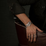 Chic silver bracelet featuring a Swarovski crystal pendant and stainless steel oval link chain, worn on a model's wrist.