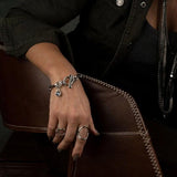 Chic stainless steel bracelet featuring a Swarovski crystal pendant and elegant T-bar closure, worn on a model's wrist.