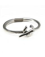 Silver-plated stackable cuff bracelet featuring a unique design with a coiled section and a distinctive clasp.