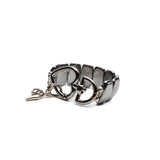 Chunky hematite cuff bracelet featuring a large gunmetal heart buckle, adjustable size with a sleek metallic finish.