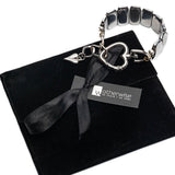 Adjustable chunky hematite cuff bracelet with a gunmetal heart buckle, presented on a black suede pouch.