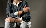 Set of edgy silver punk rings worn on a model's right hand, styled with denim jacket and white shirt.
