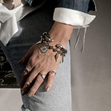Silver Edgy Punk Rings Set worn on fingers, showcasing a mix of layered silver bands with a stylish rock-chic vibe.