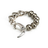 Silver-toned bracelet featuring chunky shell pearls and a thick silver-plated brass chain with a stylish clasp.