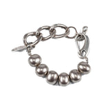 Silver-toned shell pearl bracelet with a thick brass chain, featuring adjustable length and lobster clasp closure.