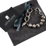 Shell pearl bracelet with silver-toned thick brass chain, featuring a mix of smooth and textured pearls.
