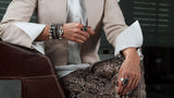 Silver-toned shell pearl bracelet with a thick silver-plated brass chain, styled on a wrist with other bracelets.
