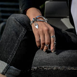 Adjustable double silver rings with chain and horse bit worn on a hand, showcasing a rock style with silver tones.