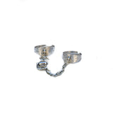 Adjustable silver rings connected by a stainless-steel chain and horse bit, featuring a textured finish.