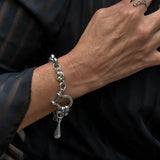 Chunky stainless steel rolo chain bracelet featuring a shackle and tea-colored Austrian crystal, styled on a wrist.