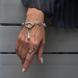 Chunky stainless steel rolo chain bracelet with silver-tone shackle, featuring a teardrop pendant and Austrian crystal.