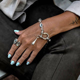 Chunky stainless-steel rolo chain bracelet with shackle, featuring a blue Austrian crystal and teardrop pendant.