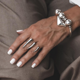 Adjustable 18K gold plated stainless steel double finger horns ring worn on two fingers, featuring a sharp, geometric design.