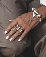 Adjustable 18K gold plated stainless steel double finger horns ring worn on two fingers, featuring a sharp, geometric design.
