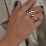 Double Finger Horns Ring in 18K gold plated stainless steel shown on a model's hand, featuring a sleek, geometric design.