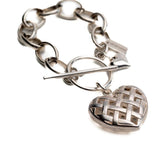 Textured heart charm bracelet featuring an antique-plated chain and a woven heart pendant.