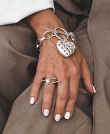 Textured heart charm bracelet in antique-plated 999 silver, featuring a unique woven heart pendant.
