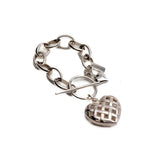 Textured heart charm bracelet with a vintage-inspired design, featuring an intricate heart pendant on an antique-plated chain.