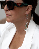 Geometric dangle earrings feature colorful Swarovski crystals, silver plating, and modern art deco design.
