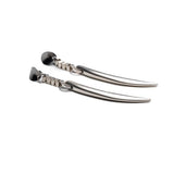 Long silver dangle earrings with tiger's tooth spikes, polished finish, and stainless steel hooks for a bold, edgy look.