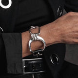 Chunky silver large hoop bracelet with horse bit design, featuring genuine black leather and an adjustable cuff fit.