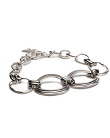 Chunky sculptural collar necklace with oversized loops, made of sterling silver plated zamak. Edgy, modern design.